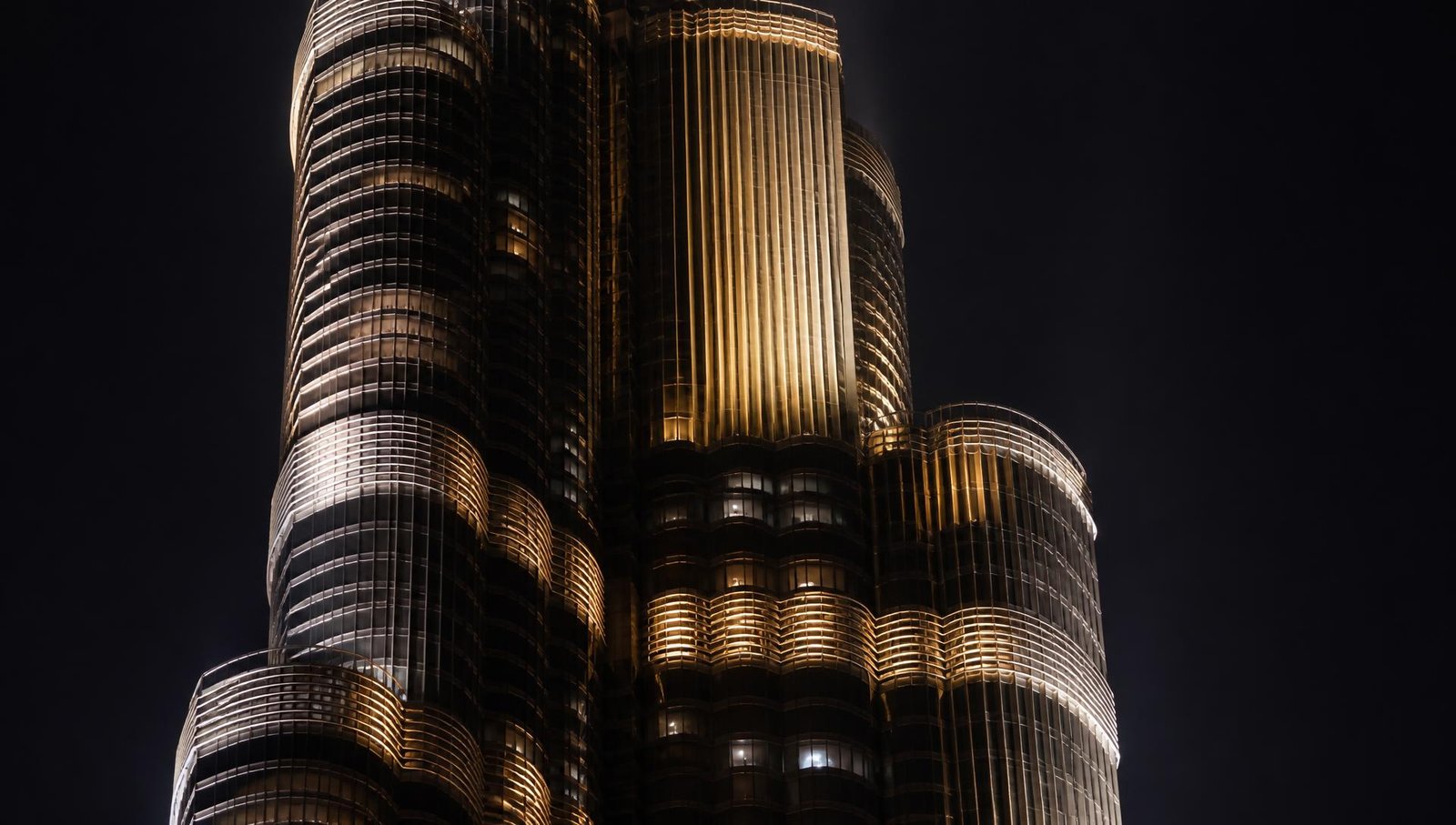 Iconic skyscraper façade illuminated at night by architectural lighting